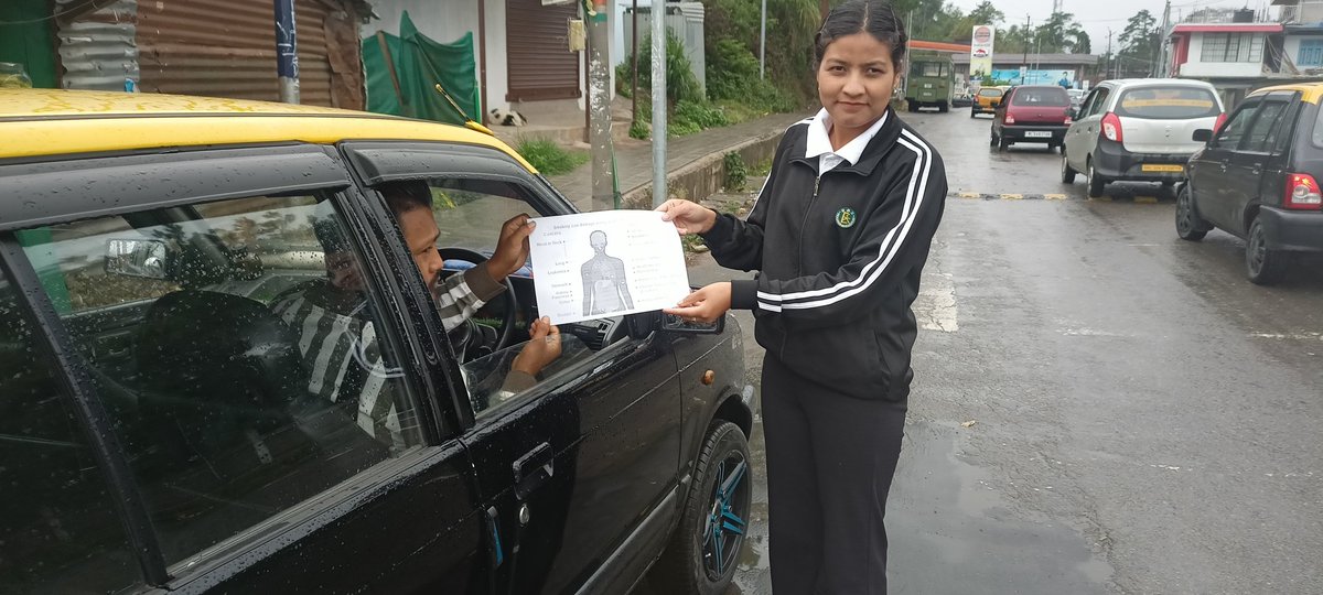 NSS volunteers distributing leaflets containing information and sensitizing people  about the bad effects of consumption of tobacco to people in town