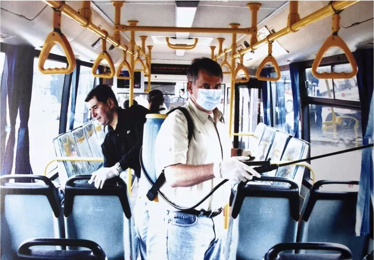 Expats in #Shanghai help disinfect a bus during the SARS outbreak, 2003.