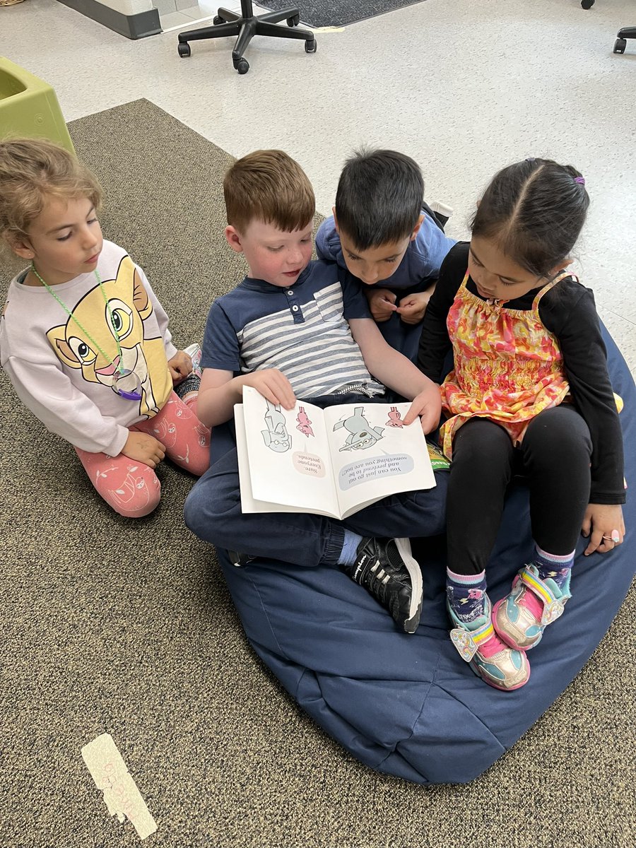 A year 2 student cozied up reading a book to year 1 students! 🫶🏻 📚 #literacy #reading #storytime #Kindergarten @StFrancisLondon @LDCSB