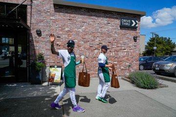 J.P. Crawford waves to fans as he leaves the Starbucks location near the ballpark. 