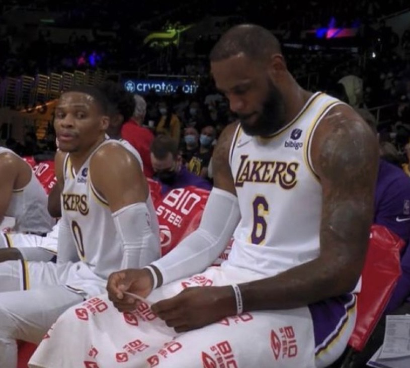 OddsStack's tweet image. Austin Reaves looking at LeBron in the locker room