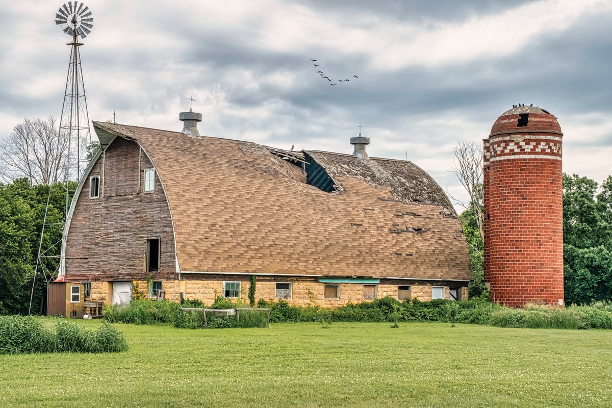 Remembering Magnificence

A king-sized dairy barn and silo built a century ago are showing their age as various parts begin to cave in through the effects of time and neglect. This barn and silo took craftsmanship from many skilled hands 

#MankatoMN #MNbarns #workcenters