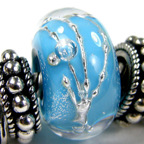 Slip this ready to wear encased dark sky blue handmade large hole lampwork glass bead wrapped in fine silver on your bracelet buff.ly/3jmcGnp via @covergirlbeads #ejwtt #BraceletBeads #LargeHoleBeads