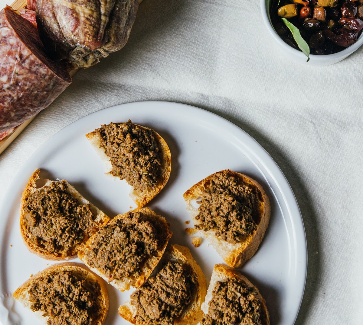 Enjoy exquisite flavors of the Crostini Neri Toscana. This traditional Tuscan appetizer features crispy toasted bread topped with a delectable spread made from chicken liver, capers, and anchovies. ⁠#foodfriday #kissfromitaly #italiancuisine