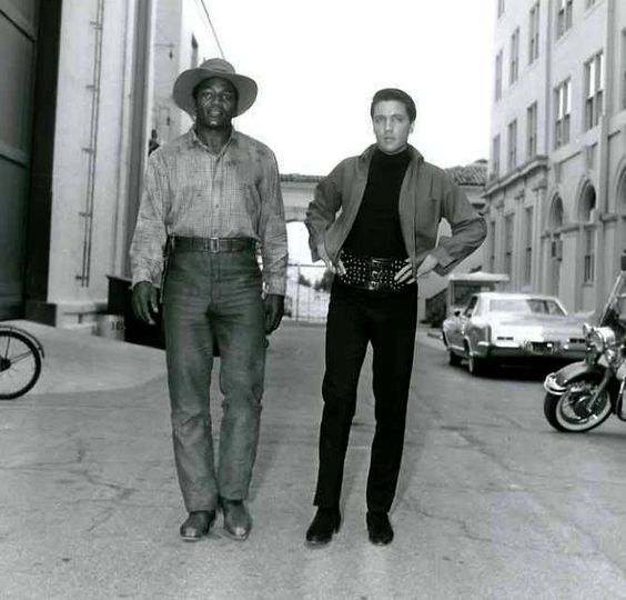 Elvis chatting with football player Jim Brown between take on the set of Roustabout in spring 1964. #ripjimbrown