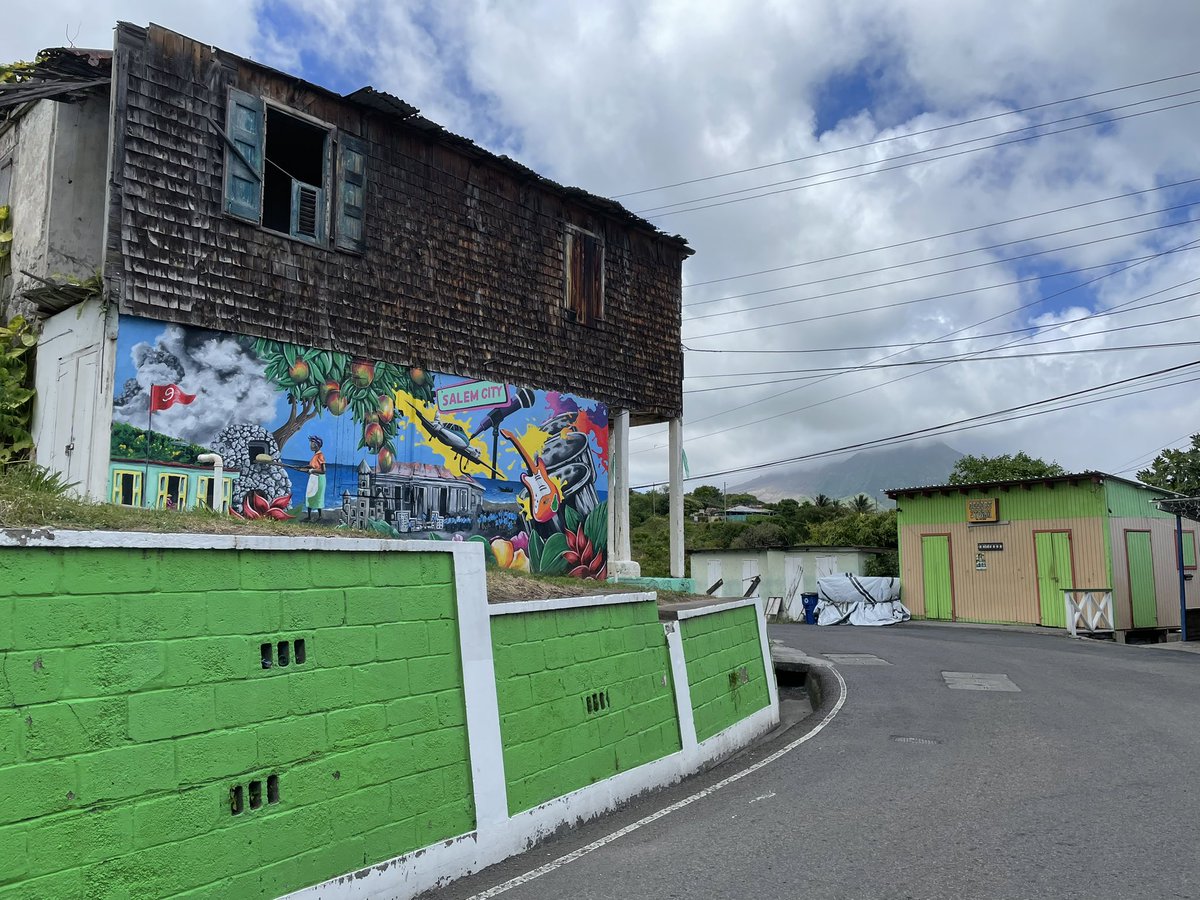 claire_horwell's tweet photo. Thanks so much @abrakaren from @mvoms for giving me a tour of the awesomely beautiful new murals on Montserrat, painted as part of @VolcanoJenni’s #CuratingCrises project. All were co-designed with the local communities! Here is the first one, in Salem. See thread for the rest!👇 https://t.co/b4m1jQemzO
