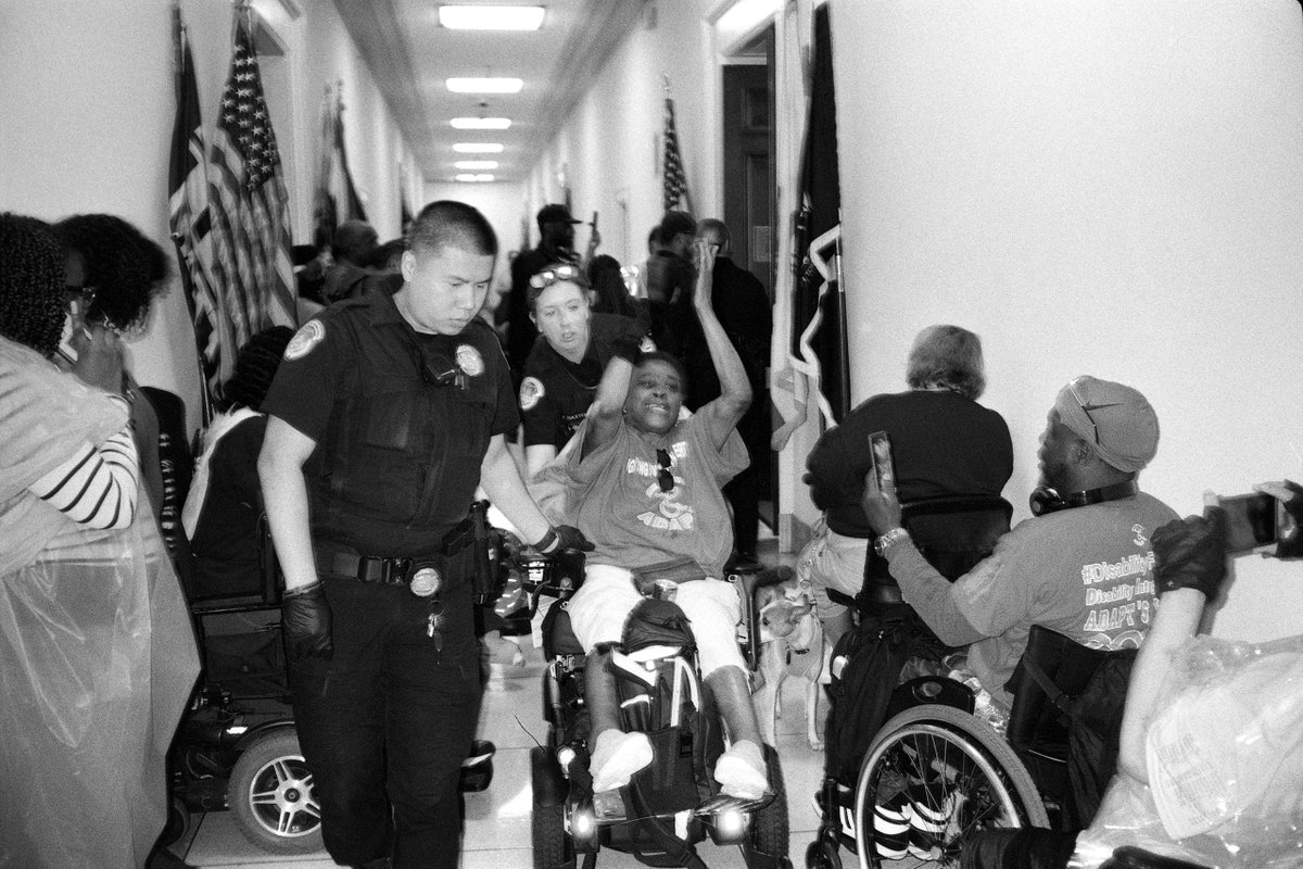 NewYorker's tweet photo. Last week, activists with the disability-rights group ADAPT lined the hallway outside Kevin McCarthy’s office. A group of them forced their way in and refused to leave. See more photographs of the demonstration: https://t.co/EmwHEcXBVD https://t.co/vshBMamGdp