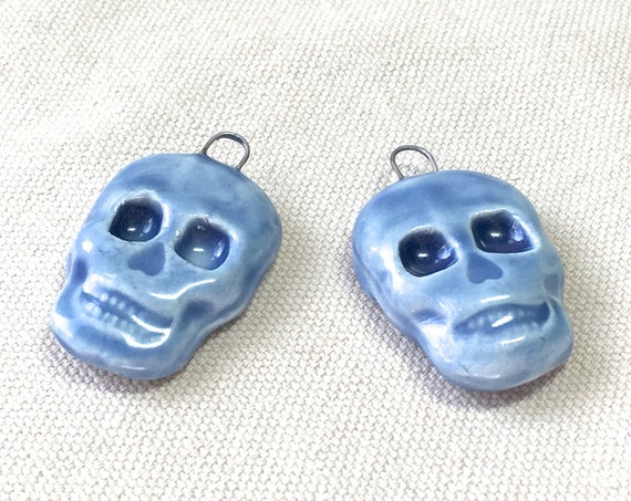 Porcelain Skull Charms, blue tinyurl.com/y6k59tgg via @EtsySocial #zencatpottery #etsysocial #handmadesupplies #stonewarepottery