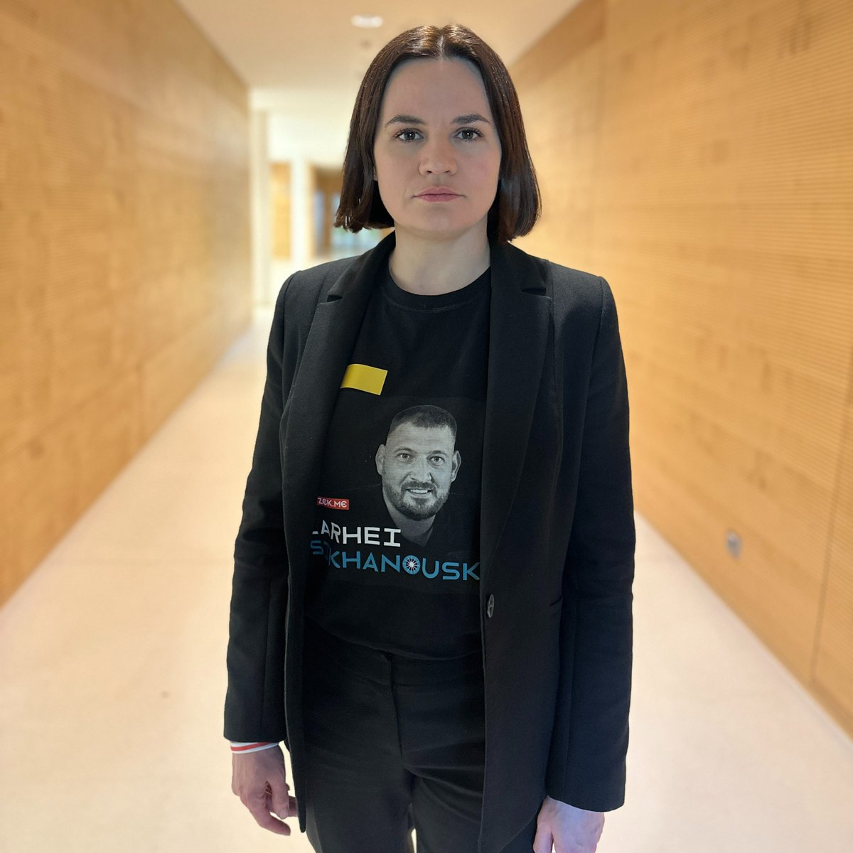 Tsihanouskaya's tweet image. Today, on the Day of Solidarity, I am wearing a t-shirt with my husband, Siarhei, on it. He has been in prison for 3 years. I didn't have any news about him for 2 months. I'm also wearing a yellow badge, the same kind that the regime forces political prisoners to wear in prisons.