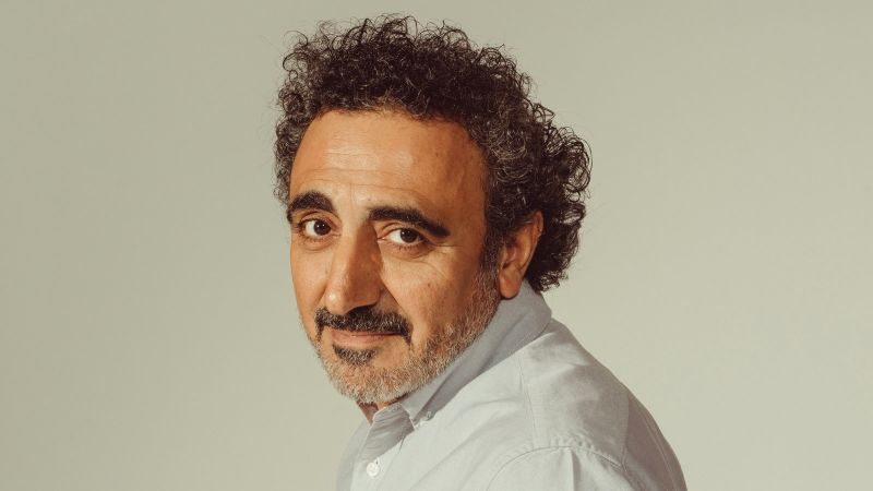 jcniyomugabo's tweet photo. This guy built a $10 billion empire on spoiled milk.

It all started with a $800k SBA loan.

The best bootstrap story you've never heard of 🧵

Meet Hamdi Ulukaya.

He grew up in Turkey.

His family was sheep herders, dairy farmers and feta cheese makers.

As a young student, he was questioned by police about his support of the Kurdish-rights movement.

He had to leave Turkey.

His friend recommended America.

But he was taught "capitalism was the reason for the suffering of poor people"

His friend told him “Don’t be stupid, go to America. Learn English.”

So that's what he did.

Hamdi got a job on a farm in Upstate New York.

He loved America but missed good cheese from home.

When his Dad visited he had the idea of making cheese with an old family recipe.

So together with one of his brothers, Hamdi started a cheese company in 2002.

They sold some cheese but were barely breaking even.

The cheese was great, but the demand wasn't there.

One day he got some junk mail:

An 80-year-old Kraft yogurt and cheese factory was for sale.

For only $700,000.

This was a fire sale.

Many of the individual machines would cost more than a million if bought new.

He had to have it.

He wrote a business plan and got 90% financing from the SBA.

With local development grants to fill in the rest.

The factory was his.

But he found one big issue after closing.

They were missing a separator.

Basically, an industrial washer-dryer that removes the milk solids from whey.

Those cost $1 million brand new. He didn't have the money.

After searching for months, he found a used one for $50k in Wisconsin.

On his drive there, he came up with the perfect name for his new yogurt:

Chobani

From the Turkish word Coban meaning shepherd.

It took him 2 years to perfect the yogurt recipe.

Consistency and flavor had to be right.

Creamy and not too tart.

He hired back many of the laid-off workers from the old factory.

Then he had to nail the container design.

Hamdi wanted the design to be different.

American yogurt had a narrow opening.

He went with a wide squat container like European yogurt.

He called it Greek because that was becoming popular.

And colorful cups to stand out.

Hamdi was ready to launch.

But he didn't want to be stuck in specialty stores.

He went straight for the biggest grocers.

He didn't have the cash to pay for the usual promotion. So he offered stores more yogurt.

It was an instant hit.

Over the next 5 years, they grew faster than Facebook or Google.

Hamdi lived in the factory.

His staff pulled all-nighters to keep up with orders.

By year 5, they had $1 billion in sales & 50% market share in the Greek yogurt market.

In 2016, Hamdi Ulukaya granted his then 2k employees roughly 10% of the company.

With a rumored valuation of $10+ billion, this works out to be about $500k+ per employee.

Many of them are factory-line workers.

Story by Colin Keeley(LinkedIn)