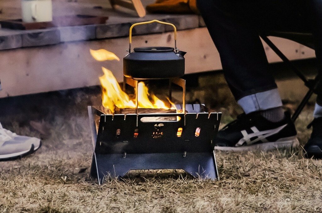 This foldable fire pit stand brings the joy of space-saving design to outdoor camping and meals