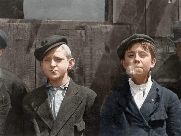1910 picture by Lewis Wickes Hine showing newspaper boys taking a smoking break in St. Louis, Missouri