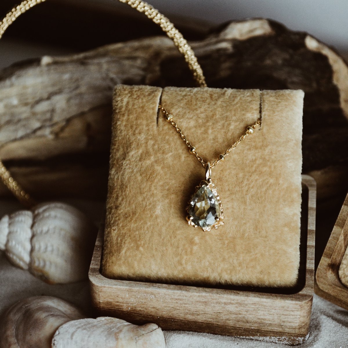 The Alba Necklace – a true work of art crafted from solid 9ct gold. This exquisite necklace is crafted with a granulation technique, and at its centre, a breathtaking 10x8 pear cut Beryl gemstone in ocean hues that shimmer in different shades of blue and green.