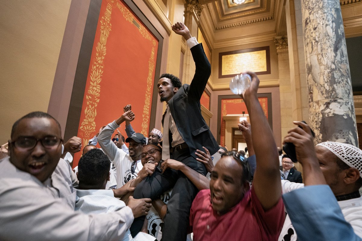 Sen. Omar Fateh (D-Minneapolis) is hoisted in the air by supporters immediately after passage of a bill that provides protections to network drivers who work for companies such as Uber and Lyft. #mnleg #mnsenate @OmarFatehMN