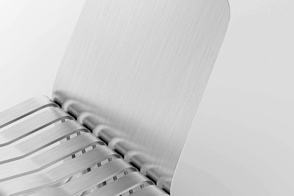 Sleek minimal aluminum + stainless steel chair was designed for quiet contemplation