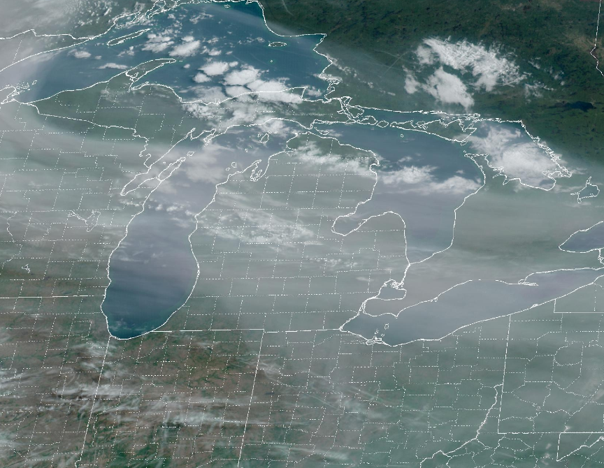 NWSDetroit's tweet photo. High altitude smoke overhead is from the Alberta wildfires. This is giving a filtered view of the sun. Here is the 9 AM visible satellite image showing the smoke over Michigan.  Note that the smoke is aloft and not at the surface. https://t.co/sMfDwfxi8s