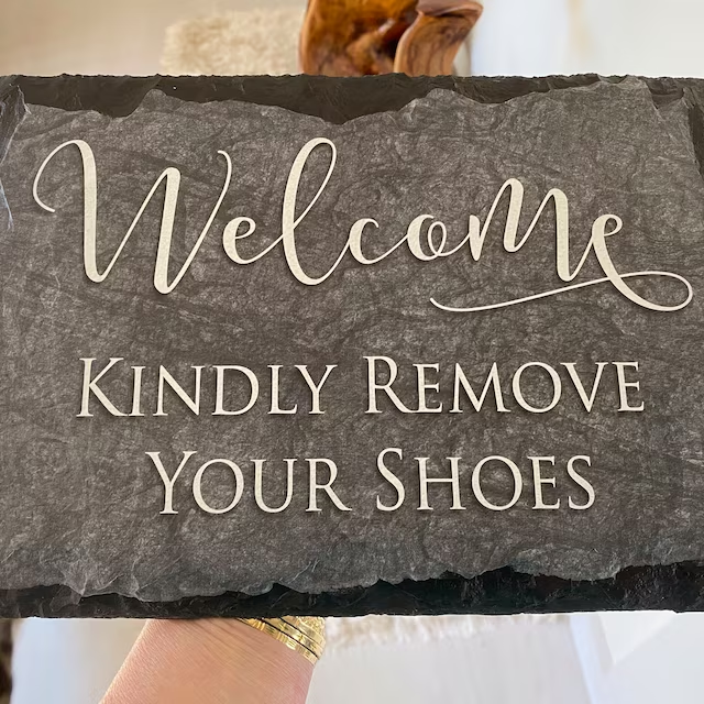 Step right in, but leave your shoes out! Our house has a 'sole' condition – no shoes allowed, but loads of comfort inside. Let your feet take a vacation while your smile gets the grandest welcome!
#welcomesign #slateplaques #homedecor #giftideas #handcrafted