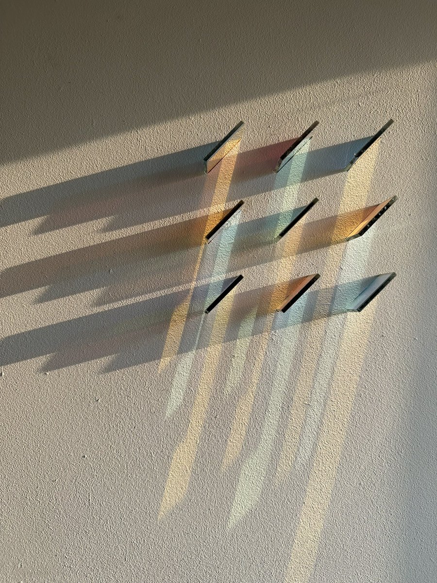 nigeldanson's tweet photo. Once upon a time I used to be a scientist and did a phd in thin film coatings. These are dichroic filters I used to design for NASA and European Space Agency.  I cut them up and mounted them to this board and they look so cool as an art piece when the light shines though them as it is doing this evening