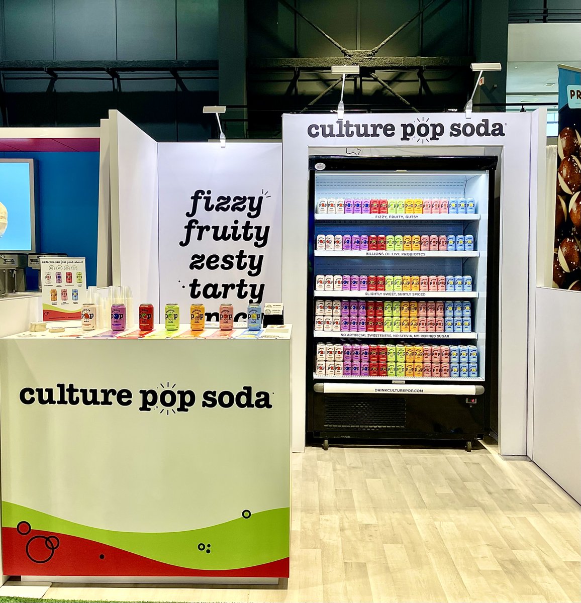 @drinkculturepop really stands out in a crowded trade show hall with this bright and bubbly 10x10 booth. The majority white finish makes their colorful branding really POP! #tradeshowlife #tradeshowexhibit #boothdesign #goodtimecreative #culturepop #nationalrestaurantshow