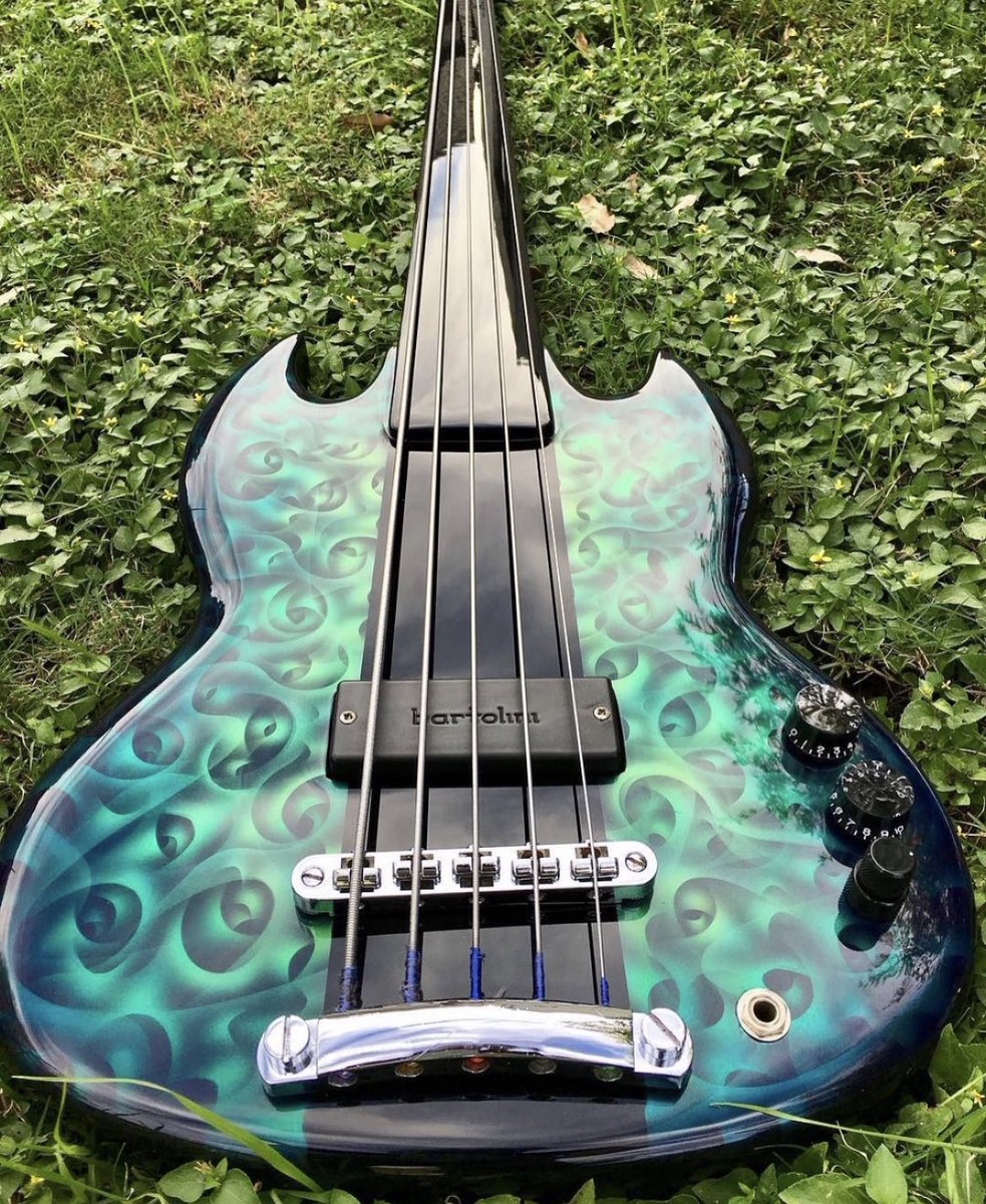 A Gibson SG Fretless Bass with a lacquered fingerboard and remarkable paint job by @custom_painter