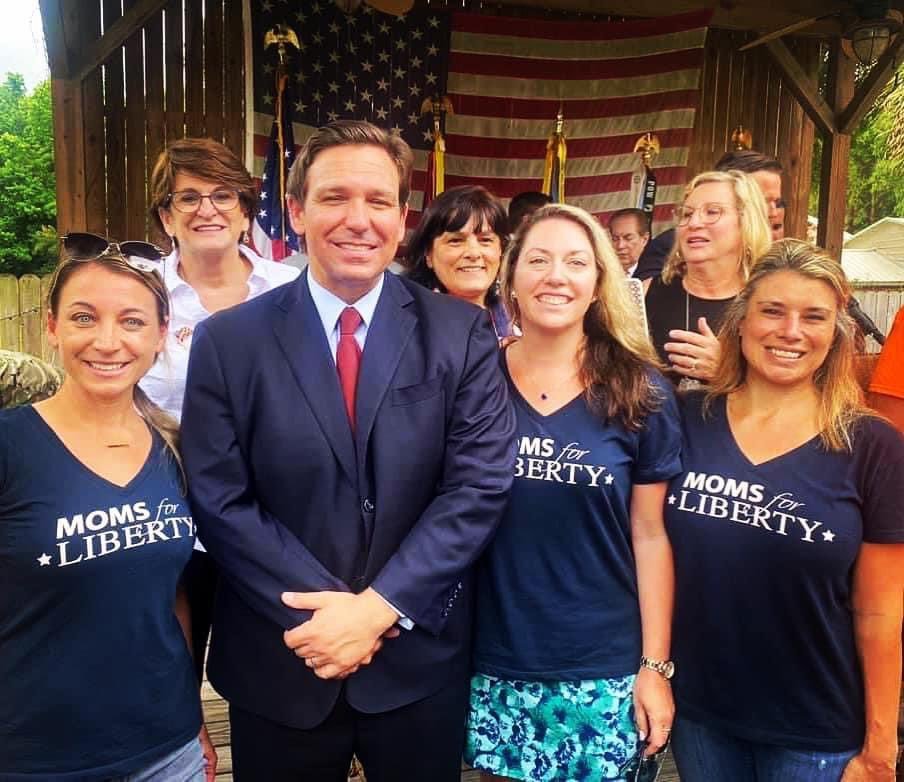 Everyone needs to see this picture of Ron DeSantis posing with a hate group (a/k/a Moms for Liberty)