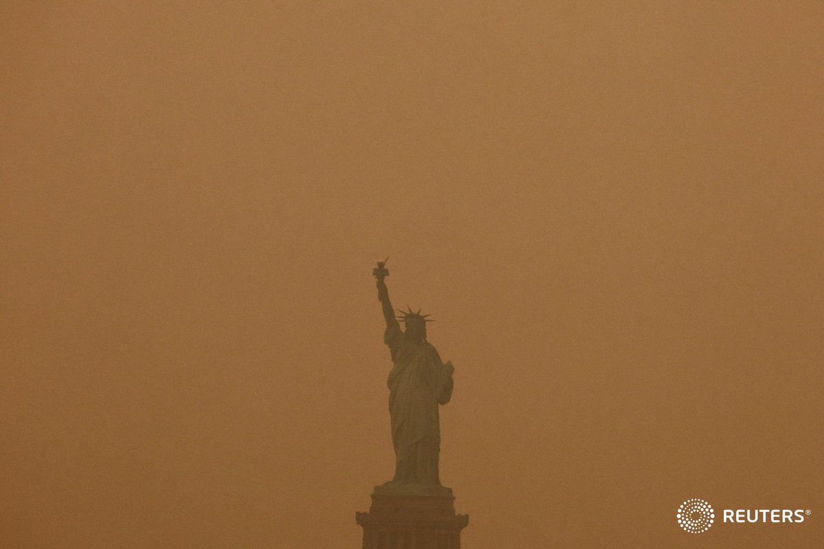 The Statue of Liberty is covered in haze and smoke caused by wildfires in Canada, in New York. Photo by @alfiky_amr