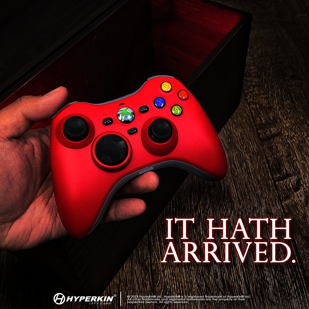 Hand holding a red Xenon over an open wooden chest glowing red. Text: IT HATH ARRIVED.