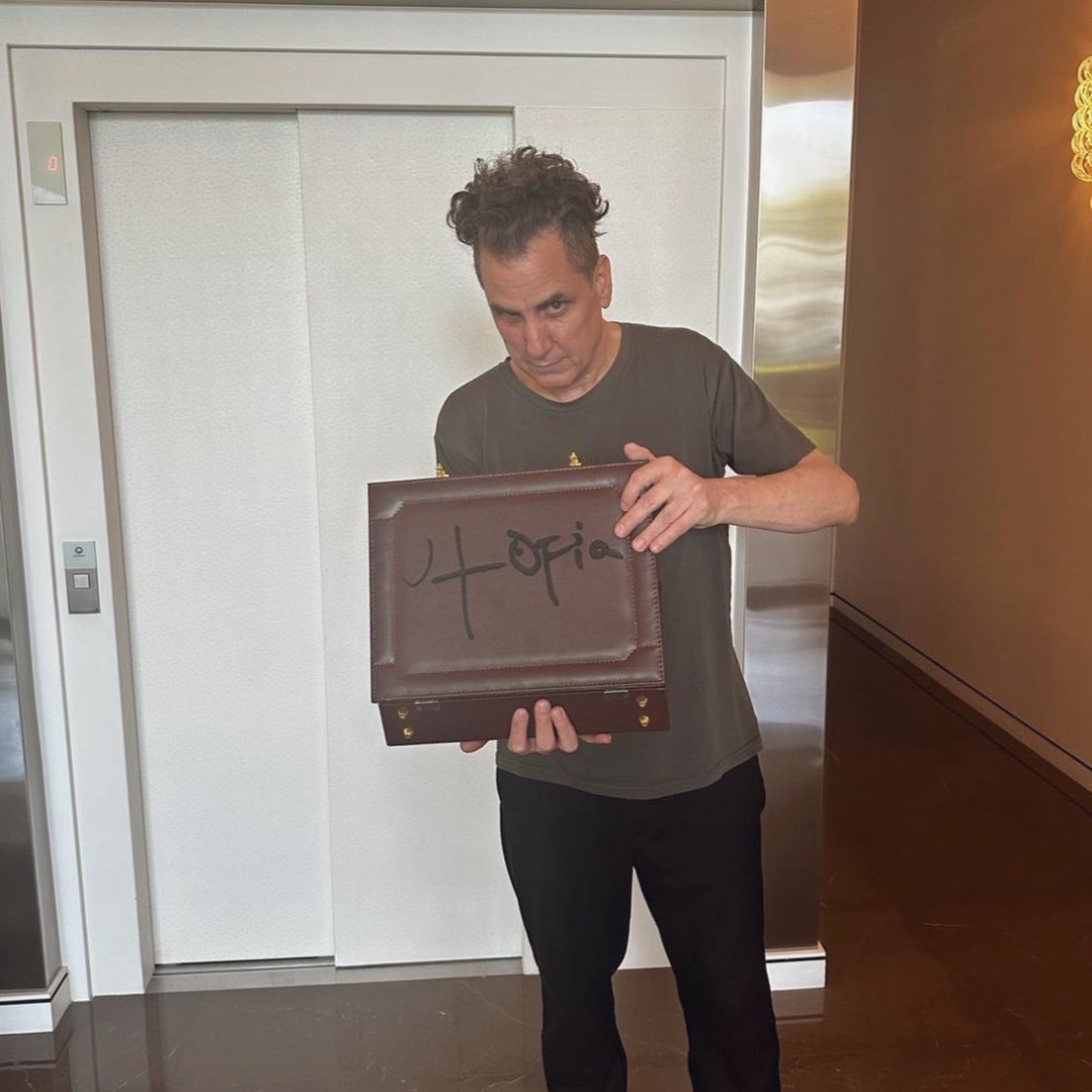 LaflameScott's tweet photo. Mike Dean with the ‘UTOPIA’ case ‼️ https://t.co/QYzXkPT7v3