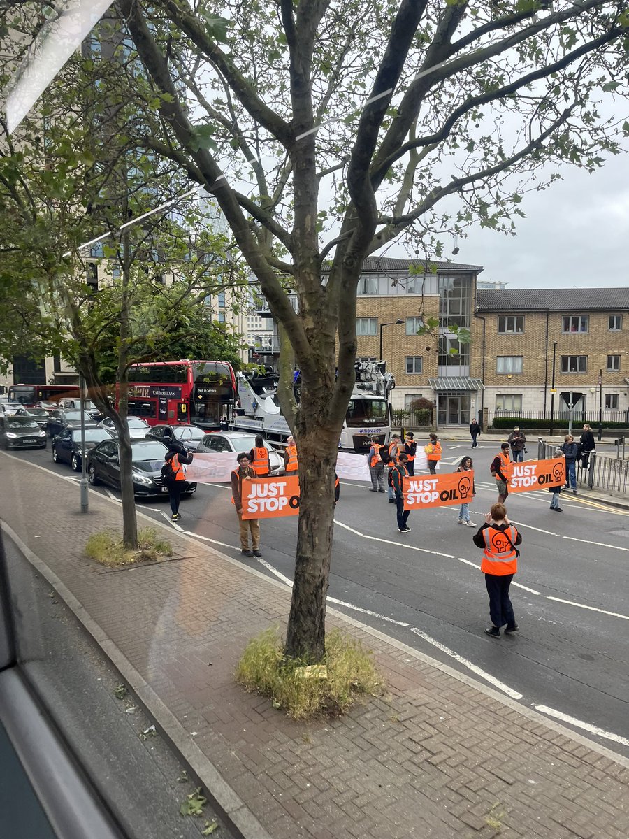 New #JustStopOil protest blocking West India Dock Road near Westferry DLR station in east London. No police on site just yet
