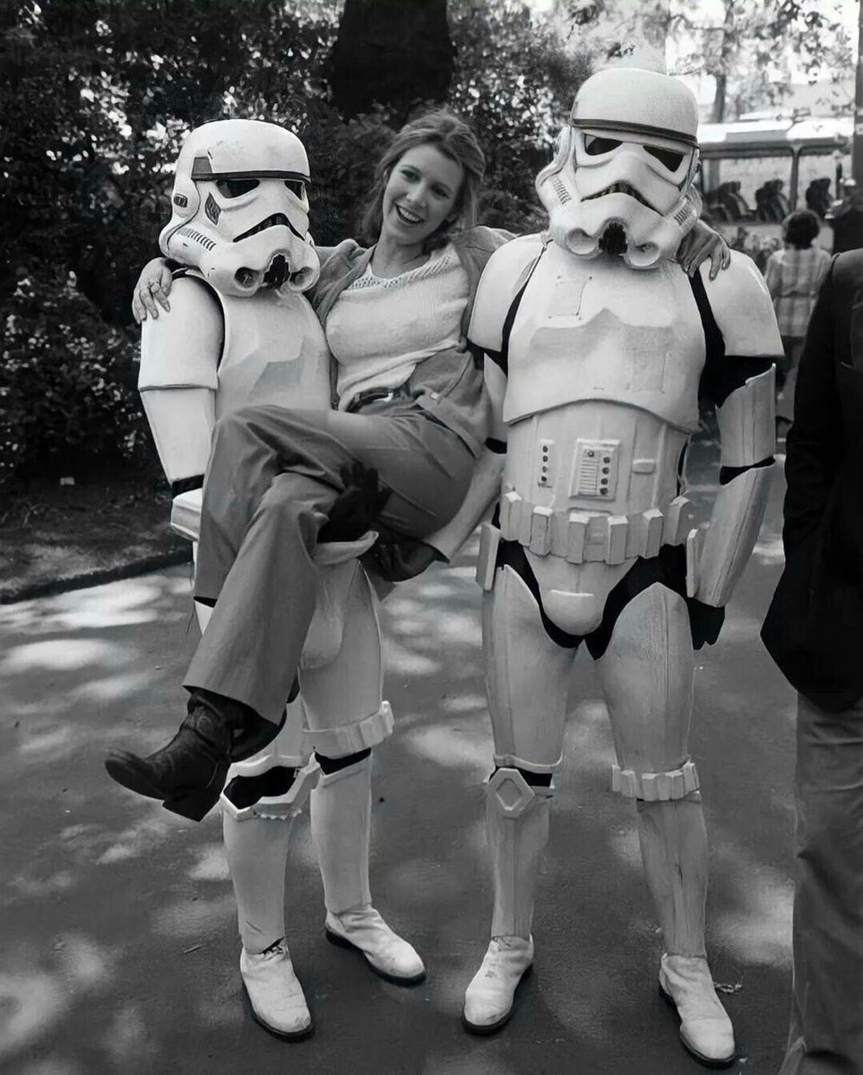 Carrie Fisher hanging out with some stormtroopers while promoting 'Empire Strikes Back' in London, 1980.

They still miss her