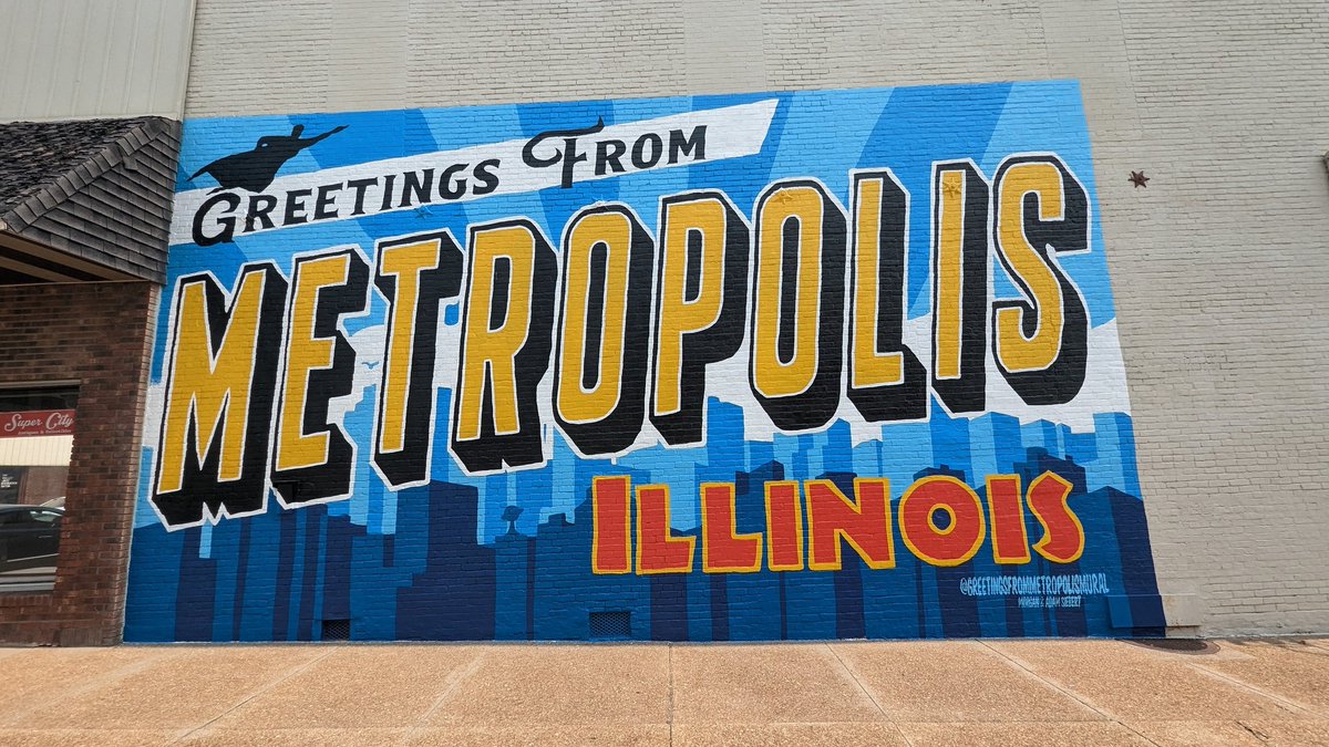 supermanmuseum's tweet photo. The Greetings From Metropolis Mural is finally complete!  We signed it this morning. Be sure to come to the ribbon cutting this Friday June 9th 🎀 ✂️ at 11am during the 45th annual Superman Celebration !  We will have signed posters available at Hidden Gems Novelty and Collectibles and the Super Museum for purchase. We want to thank everybody that helped paint with us, those that drove by and shown appreciation, Super City Antiques & Collectibles for letting us beautify their building, and the great city of Metropolis Illinois for extending the no parking on the street so visitors can take photos in front of the mural.  Be sure to tag all your mural pictures @greetingsfrommetropolismural so we can see all your smiling faces!  #metropolisillinois #homeofsuperman #supermancelebration #supermuseum