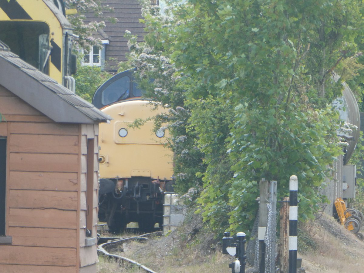 A British Rail Class 37 is just peaking out of Chinnor Yard.
