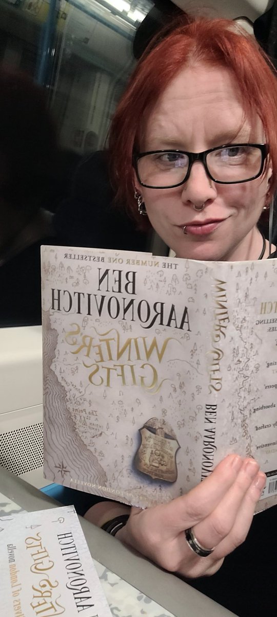 shesnotthere's tweet photo. I haven't sat down and read a paper book in a while, but when you get a copy of @Ben_Aaronovitch's new novella ahead of time and have a train journey, what else are you gonna do? https://t.co/0ZEXeX5ErW