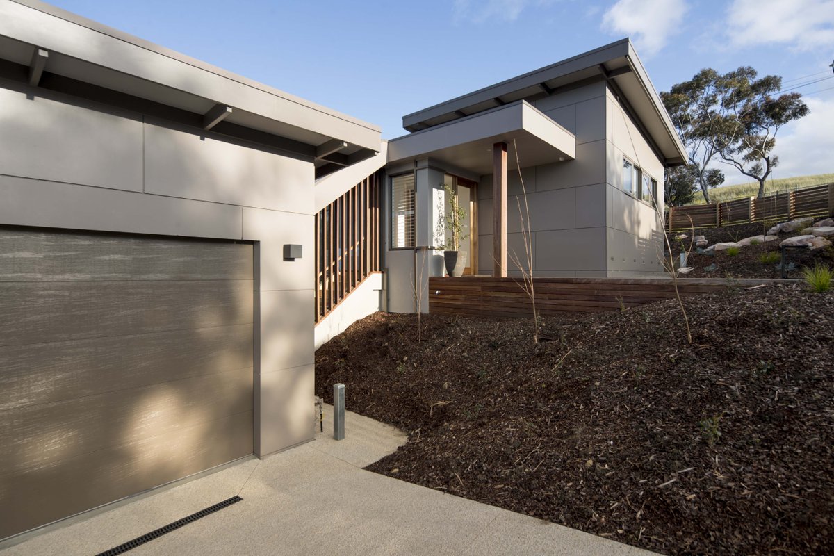 BespokeHQ's tweet photo. The layered entry of Bespoke Derbyshire House 3. The angled timber screen offers privacy to the street for the internal stair that connects the garage to the house.  Making full use of the sloping site.
Photo: @dean_walters
Builder: @derbyshirehomes https://t.co/QIaPeK2yQ2