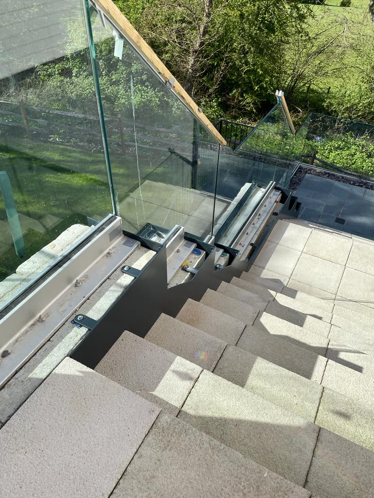 Bespoke made-to-measure frameless glass balustrade adding a modern design element to a stairway on a new build site for high-quality homes in Kent. 

Frameless glass balustrades are becoming increasingly popular for external and internal use.