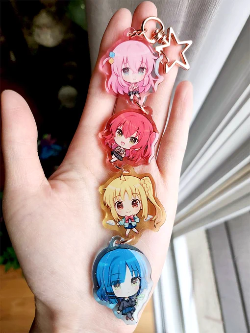 some photos i took of bocchi charm a couple weeks ago! they're glittery on both sides  my new charms will be linked too, im kinda addicted to making them now