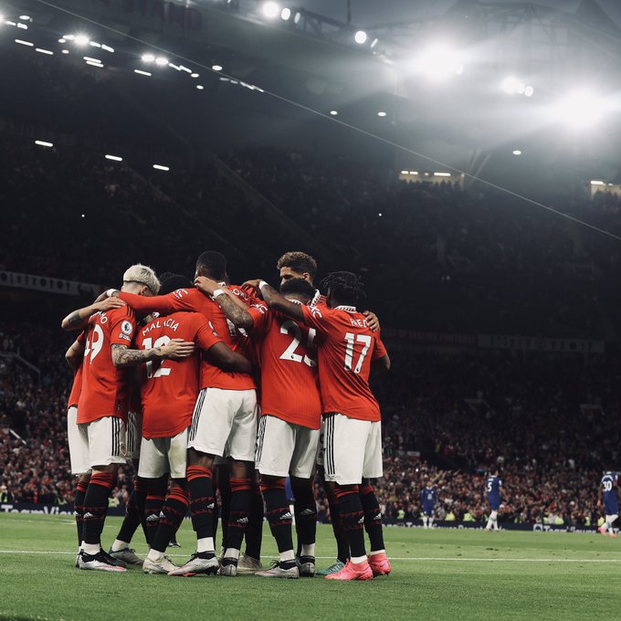 United players celebrate together after a goal v Chelsea.