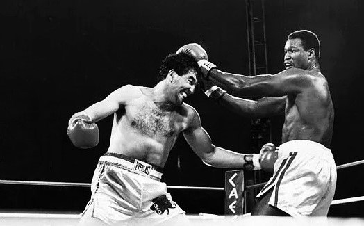 World champ Larry Holmes fends off the attack of undefeated contender Gerry Cooney at Caesars Palace in #LasVegas in 1982. In a record-setting 'superfight,' Holmes overcame Cooney's vaunted punching power to win by TKO in round 13. #Heavyweight #History #Boxing #Legends