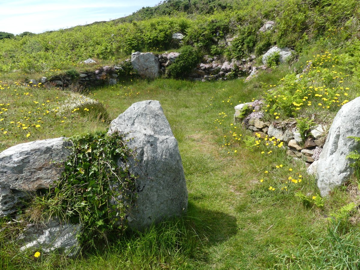 #FingerpostFriday  Sign to Holyhead Mountain Hut Circle, Anglesey.  Plus a photo of one of the Iron Age hut circles - such an atmospheric place.