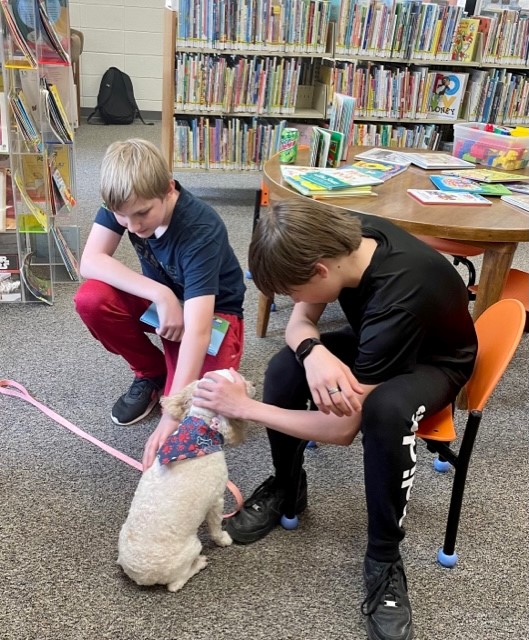 The Pine Bluffs Branch Library held a "Read Aloud to a Therapy Dog" event on Tue, May 23 featuring Madison the cockapoo and her owner Deborah Morrison with Canines for Christ.

All the attendees had a great time reading to Madison and telling her all sorts of different stories!