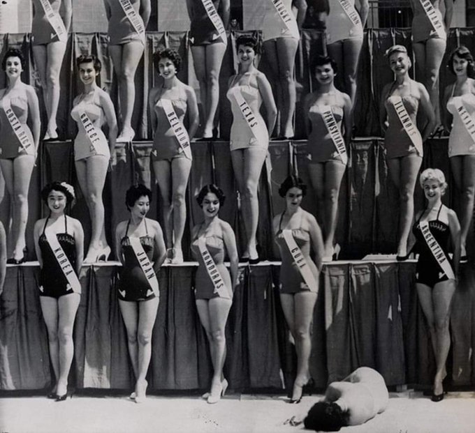 Miss Universe contestants continue to pose, even though Miss New Zealand passed out from heatstroke. Long Beach, California, 1954