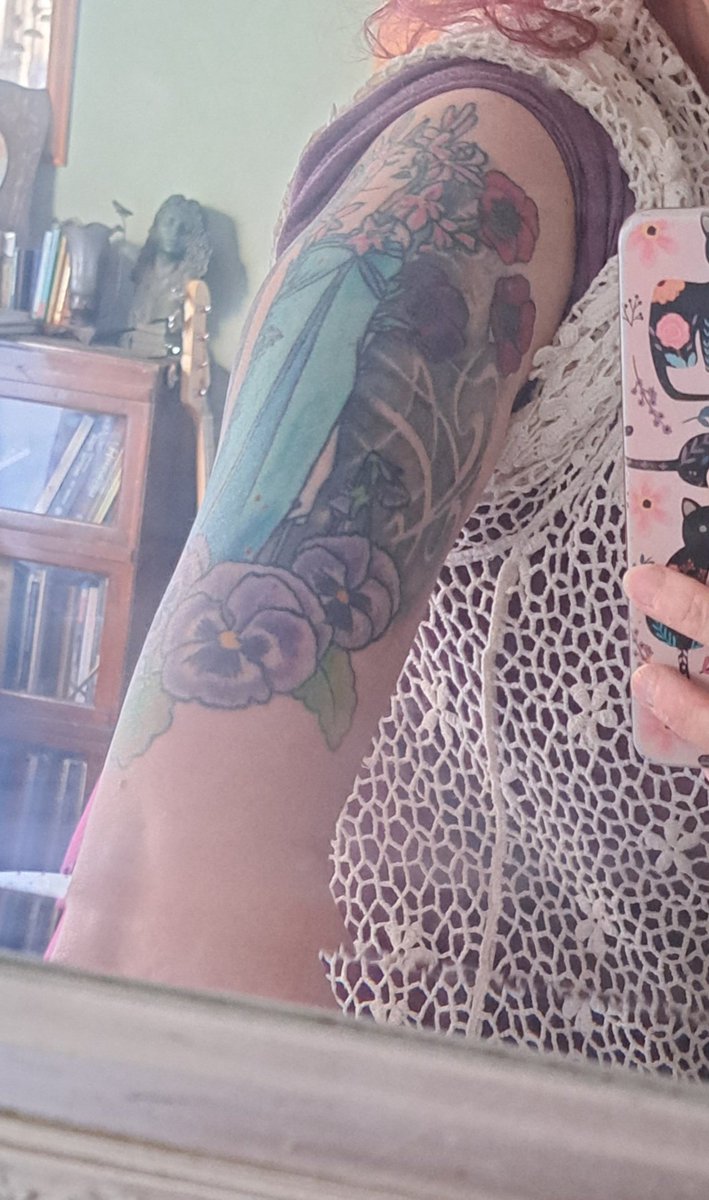 @authenticTERF Inspired by Alphonse Mucha it has pansys and anemones surrounding it. I hope to make it a fullsleeve eventually. I'm 49