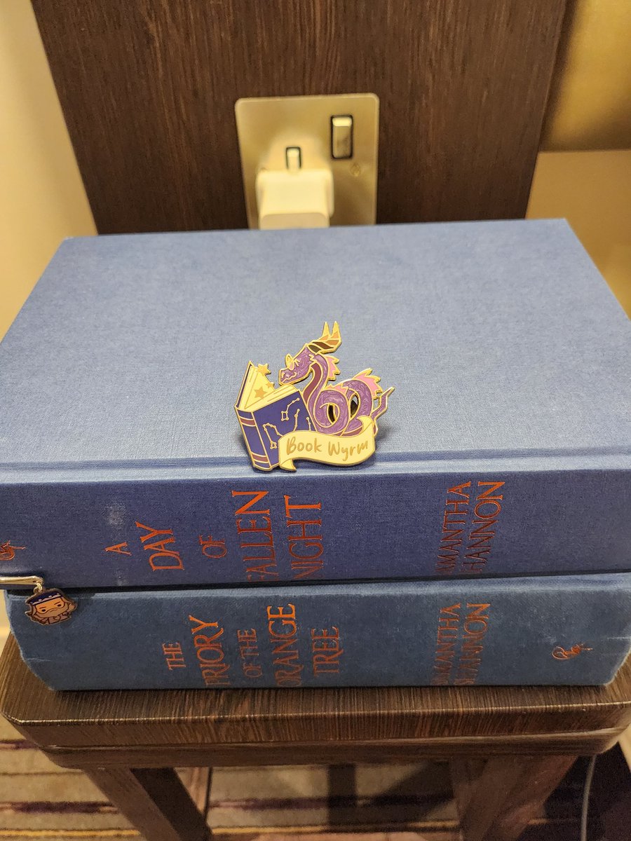PikachuPotter's tweet photo. Amazing first day at @MCMComicCon! I managed to finally meet @say_shannon and get my copy of #prioryoftheorangetree signed and thank her for breaking my reading slump. Then found this cute #wyrm pin which fits perfectly for hopefully finishing #dayoffallennight https://t.co/Q235cHy6iR