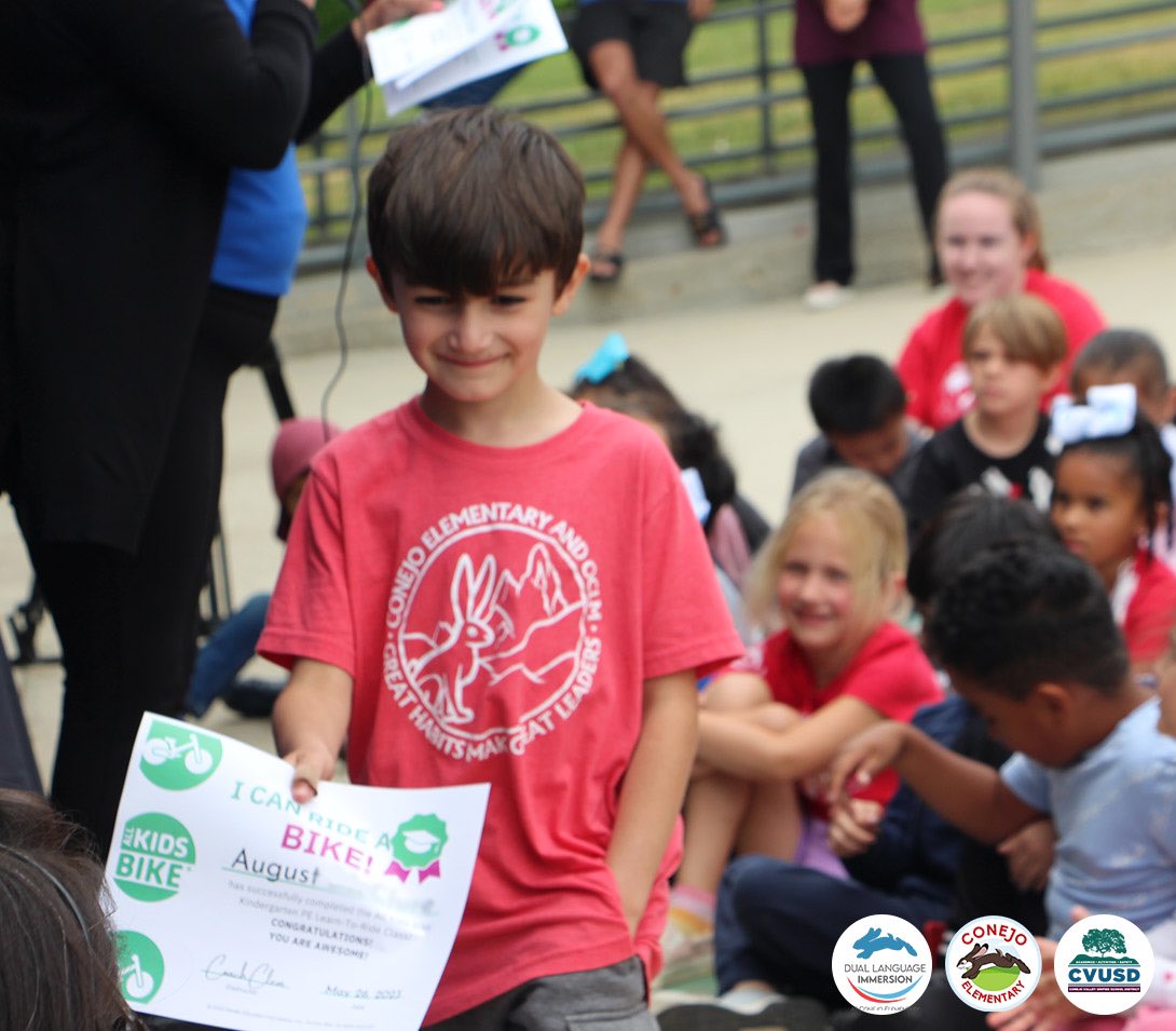 ConejoValleyUSD's tweet photo. Conejo Elementary students earned their license to ride..BICYCLES! Kindergarteners &amp; 1st graders completed an 8-week All Kids Bike PE curriculum, culminating w/ a Bike Graduation today. The biggest surprise? Each child received a free bike thanks to NP Bike Shop &amp; Giant Bicycles. https://t.co/t8JGDhVmGv