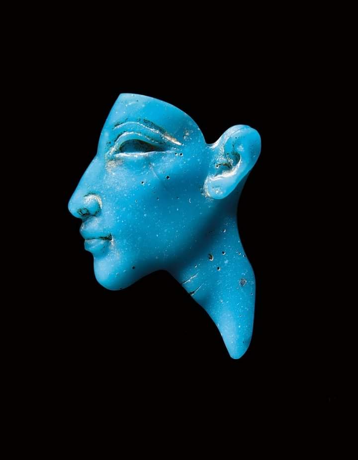 The image shows a beautiful faience or turquoise glass decorative sconce, with the effigy of King Akhenaten, which was found in Amarna, and is now part of a private collection.

It was made by an unknown craftsman during the reign of that pharaoh, around 1345 B.C.