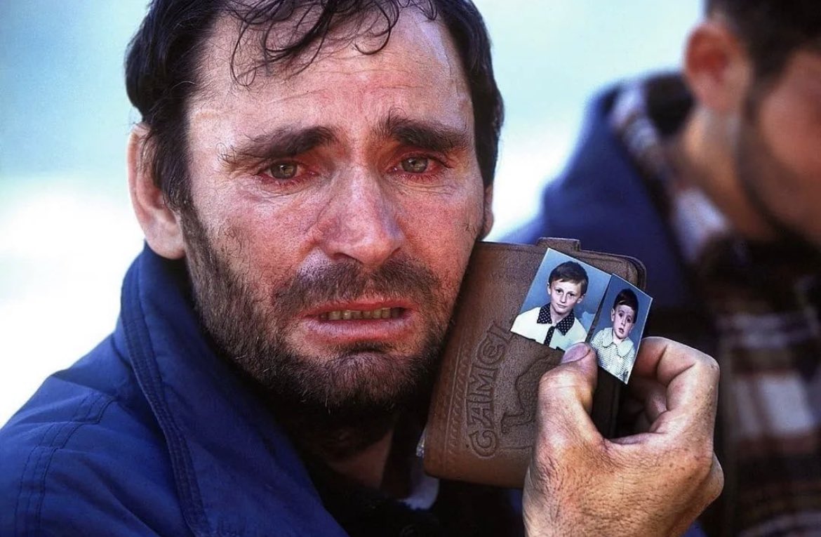 historyinmemes's tweet photo. In 1999, during the Kosovo War, Mustafa Xaja, an Albanian man, held up a photograph of his two missing sons. Despite the chaos and danger of the war, Mustafa's entire family, including his sons, managed to survive, and they were joyfully reunited after the conflict ended. The war in Kosovo involved the Federal Republic of Yugoslavia (Serbia and Montenegro), who controlled the region prior to the war, and the Kosovo Albanian rebel group known as the Kosovo Liberation Army (KLA). The KLA fought against the Serbian persecution of Kosovo Albanians, while the FRY sought to maintain control over the area.

Lasting from 1998 to 1999, the war concluded with the intervention of the North Atlantic Treaty Organization (NATO), who conducted airstrikes that compelled the Yugoslav forces to withdraw from Kosovo. Both sides in the conflict committed war crimes and engaged in horrific acts of violence. The war was marred by ethnic tensions, issues of identity and independence, leading to a confusing and often misunderstood timeline.

Tragically, the war claimed the lives of 13,500 people and inflicted lasting pain by tearing families apart. The anguish and sorrow in Mustafa's eyes convey the depth of his experience.