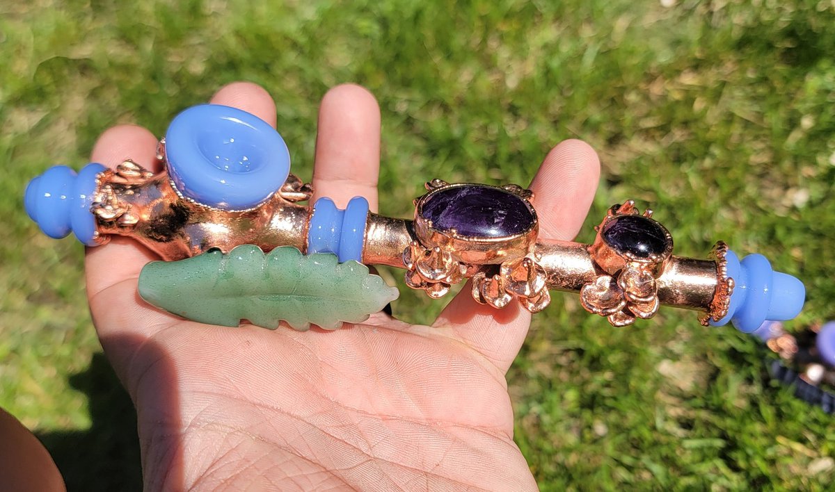 Lilac peace pipe draped in amethyst cabochons. It radiates with mirror coat copper and mushroom adornments.

Like, if you'd smoke out of this!