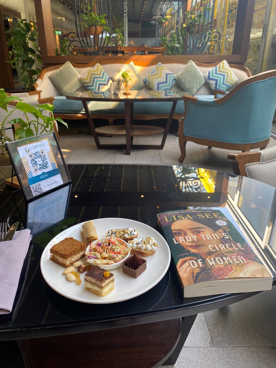 Lisa_See's tweet photo. Love this photo sent by Sarah Blumenfeld, who's reading an advanced reader's copy of LADY TAN'S CIRCLE OF WOMEN and having tea in Dubai in preparation for an event I'll be doing next month for Lafayette Library and Learning Center Foundation. Travel! Tasting looking treats! https://t.co/Px3omcT97R