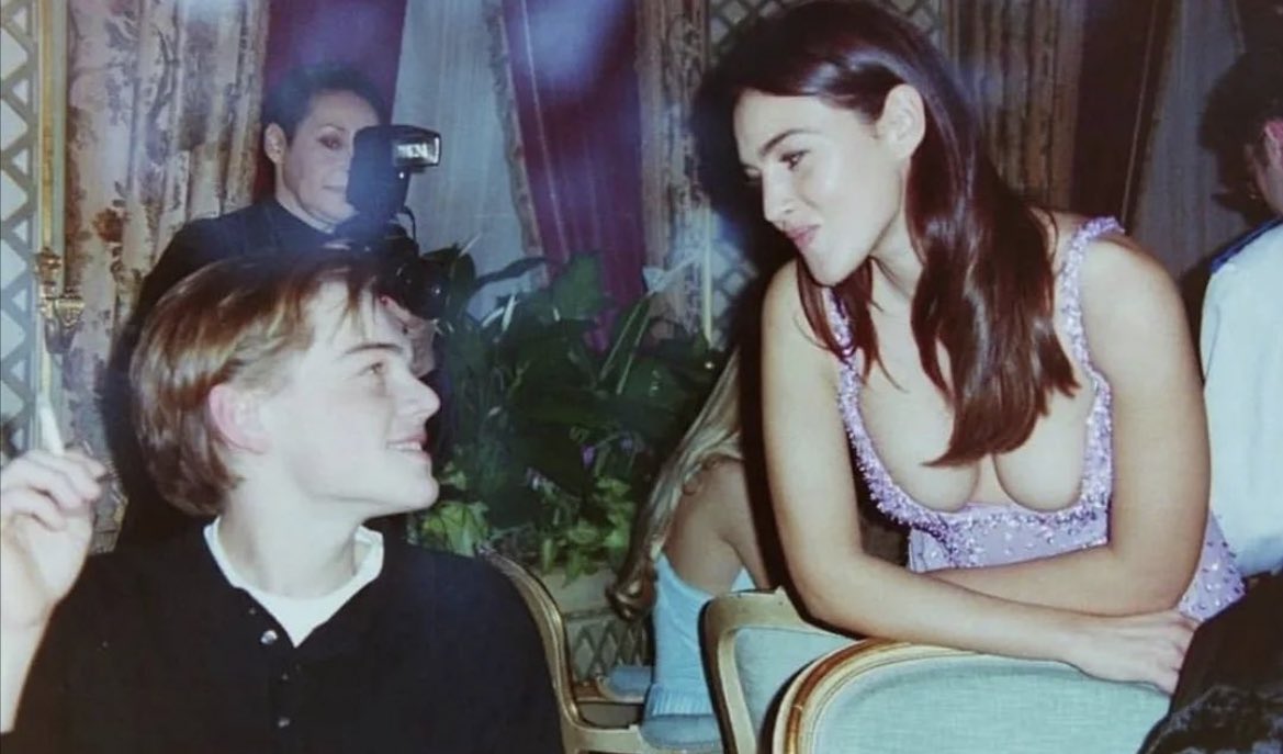 samfabelman's tweet photo. candid of leonardo dicaprio and monica belluci at a versace dinner in paris, 1995. https://t.co/EZ0HFaIwFE