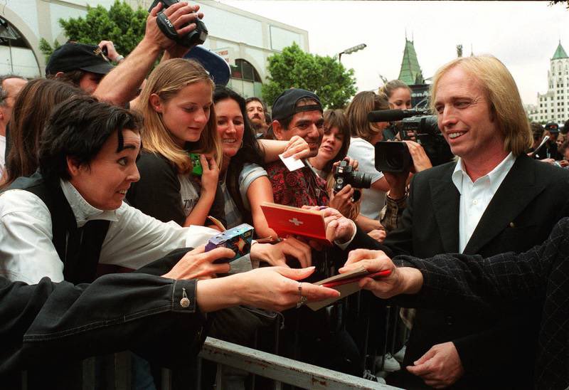 Tom signing autographs at the Hollywood Walk of Fame in April 1999. 

Photo by Damian Dovarganes